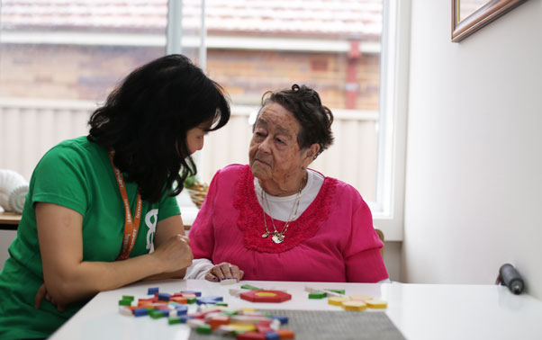 A benevolent society carer with an aged care client at home