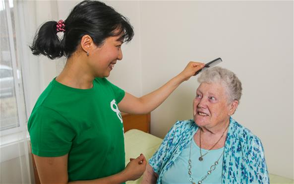A Benevolent Society staff assisting a senior client with her personal care