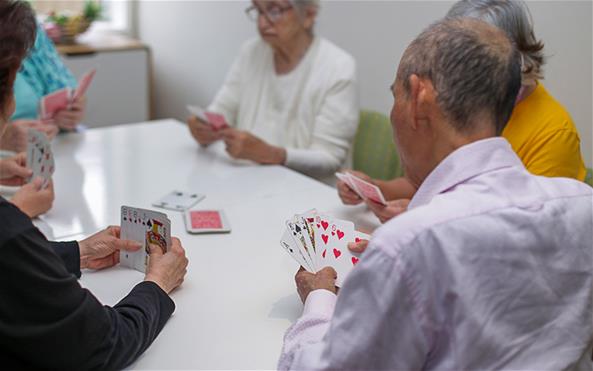 A group of senior clients of the Benevolent Society playing cards