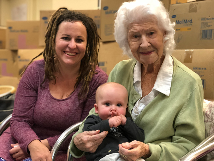 Elderly lady holding a baby and her mum