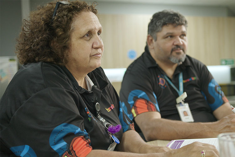 A photo of two Indigenous staff members at The Benevolent Society. They are facing right