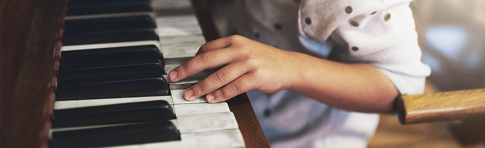 A young child playing the piano