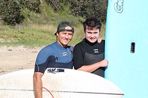Dane-with-surfboard-and-his-surf-coach.widget.jpg