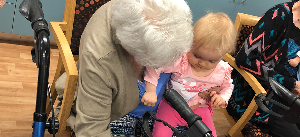 Elderly lady holding a baby and her mum