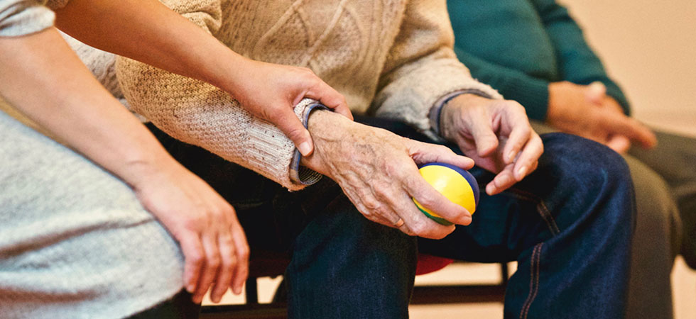 Elderly man hands holding ball