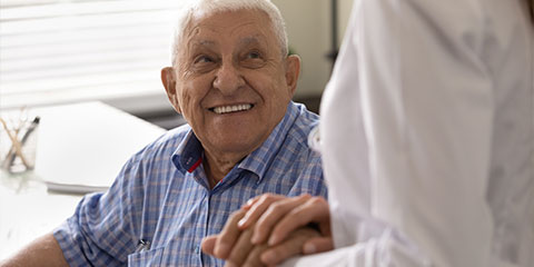 An older male looking upwards at his carer